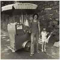 B+W photo of food seller with hot dog cart on River Road for a bi-centennial event, Hoboken, no date, [1976].