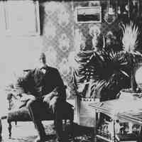 B+W 4" x 5" glass-plate negative image of James Miller seated in the parlour at 716 Bloomfield St., Hoboken, no date, ca. 1890.