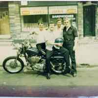 Color photo of Donald or Ducky Fontana with 3 men & motorcycle outside restaurant, Hoboken, n.d., ca. 1965.