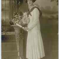 Sepia-tone photo of young woman posed in studio, Hoboken, n.d., ca. 1900-1920.