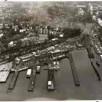 B+W negative: aerial view of Stevens Institute of Technology campus & Penn Central Railroad waterfront facilities, Hoboken, no date, ca. 1968-1975.