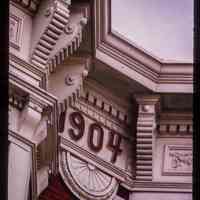          Color slide of detail view of cornice, brackets, dentils, bay windows and frieze reading 