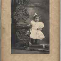 Sepia-tone photo of an unidentified young girl, ca. 3 years old, in photo studio, Hoboken, no date, ca. 1900.