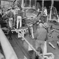 B+W photo showing workers repairing damage on the main deck on unidentified vessel at Bethlehem Steel Shipyard, Hoboken Division, no date, ca. 1940.