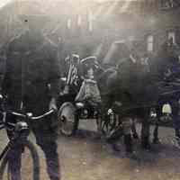 Sepia tone photo of 3rd Annual Hoboken Baby Parade, King & Queen royal carriage, on Garden between 10th & 11th Sts., Hoboken, Sept. 8, 1915.
