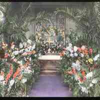 Lantern slide, color, of a church interior with floral decorations, used for promotional display in Hoboken, no date, ca. 1920.