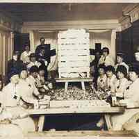 Sepia-tone photo of American Red Cross volunteers filling bags with candy for WW I troops, Hoboken, n.d., ca. 1917-1919.