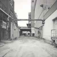 Digital image of B+W photo of former Maxwell House Coffee plant exterior, looking north between Extraction Building & Storage Silos, Hoboken, 2003.