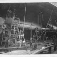 B+W photo of workmen doing propeller mounting on unknown ship in dry dock, Hoboken, no date, ca. 1940.