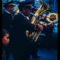 Color slide of men playing tubas in a parade.