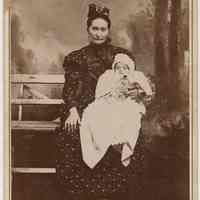 Cabinet photo of a woman & baby posed in photographer