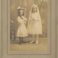 Sepia-tone photo of two young girls posed in photographer
