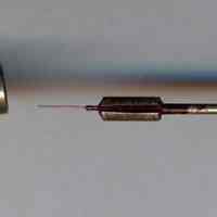          typical container open with contents: pen head and cleaning pin
   