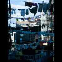 Color slide of laundry hanging between buildings.