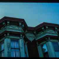          Color slide of close-up view of cornice, brackets, frieze reading 