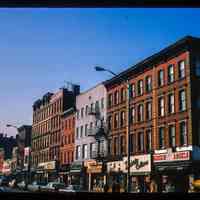 Color slide of eye-level view from the NE corner of Washington & 4th looking S at storefronts showing the Bargain Angels store