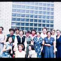 Color slide of a group of women in front of a building.