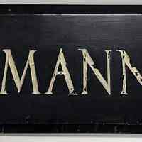 Metal wall sign: R. Neumann & Co. 9" high x 36" long x 3/4" thick. Black painted metal with white lettering. No date, ca. 1920-30.