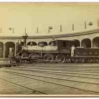 Sepia tone photo of Delaware, Lackawanna & Western R.R., M. & E. Div. locomotive 101, "Oxford", outside roundhouse, Hoboken, Apr.10, 1886.