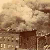 Sepia-tone photo of 1900 pier fire taken from a roof top appearing to be on 2nd or 3rd Sts., Hoboken, no date, ca. June 30, 1900, later print, 1913.