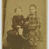 Carte-de-visite of young girl & boy posed in photo studio, Hoboken, n.d., ca. 1880-1887.