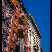          Color slide of detail view of façades, cornices and fire escapes at 410 Washington and the Lining Store building at 412 Washington between 4th & 5th showing a sign reading 