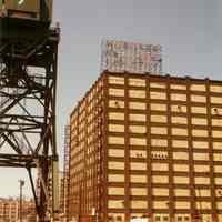 Color photo of Hoboken Welcomes Industry sign atop Lipton Tea / Standard Brands building, Hoboken, April 1982.