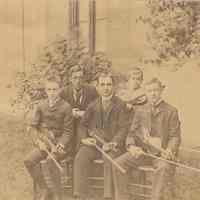 Sepia-tone group photo of 5 musicians seated in the yard at the German Evangelical Church, Hoboken, no date, ca. 1900.