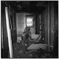 B+W photo of Robert Foster doing interior demolition at 63 Willow Terrace, Hoboken, n.d., ca. 1993-1994.