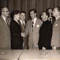 Digital image of b+w photo of Mayor Fred DeSapio shaking hands with a teenage boy with others looking on, Hoboken, no date, ca. 1950-53.