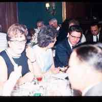 Color slide of a group of people at a table.