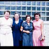 Color slide of four women in front of a building.