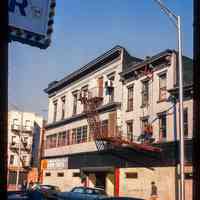 Color slide of eye-level view of unidentified building façades with fire escape on 1st between Bloomfield and Garden