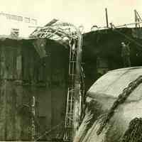 B+W photo of a closer view of major damage to an unidentified freight vessel in dry dock, possibly in Hoboken, no date, ca. 1940.