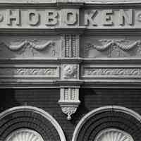 B+W photo of lettering "Hoboken" on apartment building cornice, Hoboken, no date, circa 1990-1995.