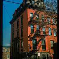          Color slide of eye-level view of side and rear façades, mansard roof, and fire escape at 636 Hudson on the SW corner of 7th picture number 1
   