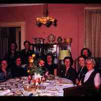 Color slide of a group of women around a table.