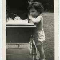 B+W photo of Mary Anne Amoroso with baby sister Dolores in carriage, 818 Bloomfield St., Hoboken, n.d., ca. late 1940s.