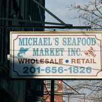 Color photo of a hanging sign for Michael