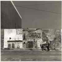 B+W photo of painted wall murals on plywood fence, Hudson St., near one of the then-new parking garages, Hoboken, no date, [1976].