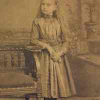 Sepia-tone photo of a girl posed in photographer