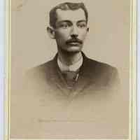 Cabinet photo of young man posed in photo studio, Hoboken, n.d., ca. 1885-1892.