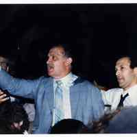 Color photo of mayoral candidate Tom Vezzetti in front of City Hall with supporters on election night, Hoboken, [June 11, 1985].