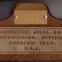 Wall plaque from Bethlehem Steel Shipyard commemorating retirement of Benny J. Fernandez, father of donor Ben Fernandez.