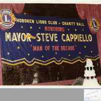 Photos, 2, of banner for Hoboken Lions Club Charity Ball Honoring Mayor & Freeholder Steve Cappiello, "Man of the Decade," Union Club, Hoboken, May 16, 1982.