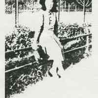 Black-and-white photocopy of photo of Adele Quattrocchi leaning against a fence in Tenth St. Park, (Columbus Park), Hoboken, no date, ca. 1940.