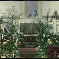 Lantern slide, color, of a church interior with floral decorations, used for promotional display in Hoboken, no date, ca. 1920.