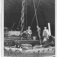 B+W photo of workers working on an anchor of an unknown ship in dry dock, Hoboken, no date, ca. 1940.