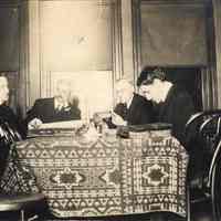 Sepia tone photo of Elysian Camera Club committee meeting, 307 Washington St., Hoboken, Jan. 11, 1915.