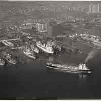 B+W aerial photo of S.S. Houston, Seatrain Lines, approaching dock; USS Compass Island, USNS Vanguard & other ships at Bethlehem Steel Hoboken Shipyard, n.d., ca. 1969.